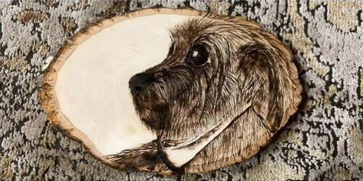 Wood round with dog design artfully burned in to the surface